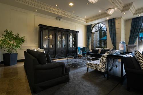 a living room with couches chairs and a table at Dann Carlton Quito in Quito
