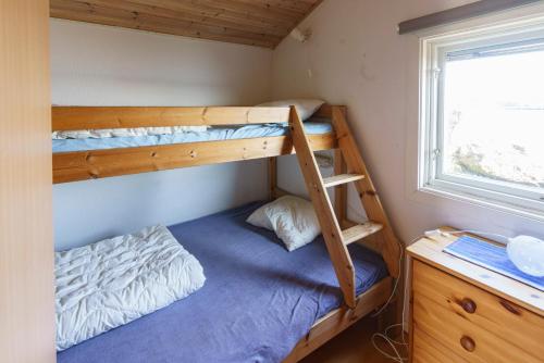 a bedroom with two bunk beds and a desk at Femöre Marina in Oxelösund