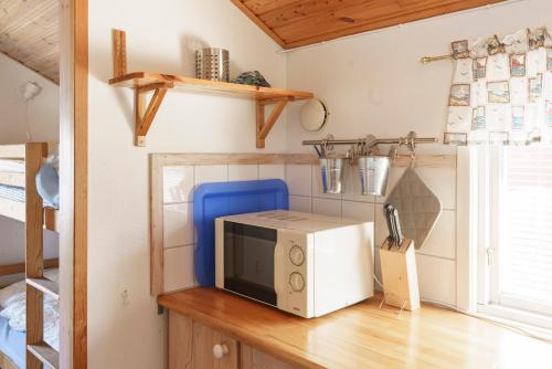 a microwave sitting on top of a wooden table at Femöre Marina in Oxelösund