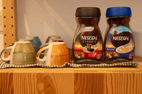 a shelf with two bottles ofadobeadobe cheese and other ingredients at Domus Montebello in Rome