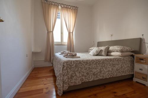 a bedroom with a bed and a window at Domus Montebello in Rome