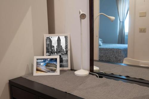 two pictures sitting on a dresser in a bedroom at Domus Montebello in Rome