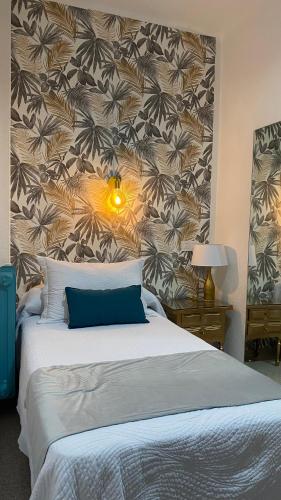 a bedroom with a large bed with a wall at Rincón Extremeño in Plasencia