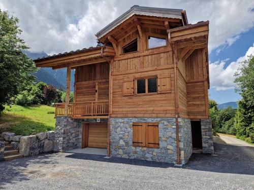 a wooden house with a balcony on top of it at Chalet Manala in Chamonix-Mont-Blanc