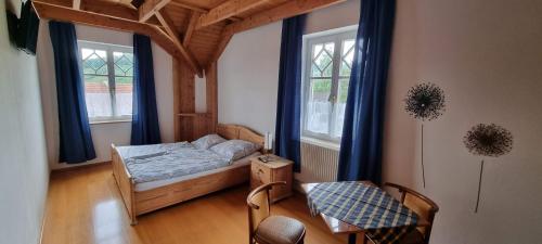 a bedroom with a bed and two windows at Villa Theresa in Hofstetten