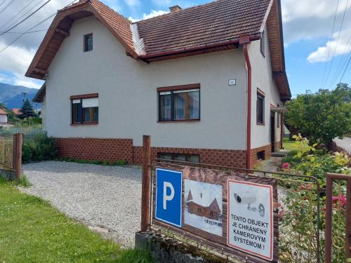 a house with a parking sign in front of it at Drevenica Západné Tatry in Žiar