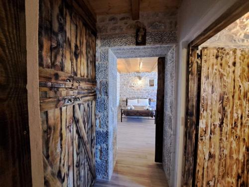 a hallway with wooden walls and an open door at Suite of Villa Lagkadaki in Agriliá