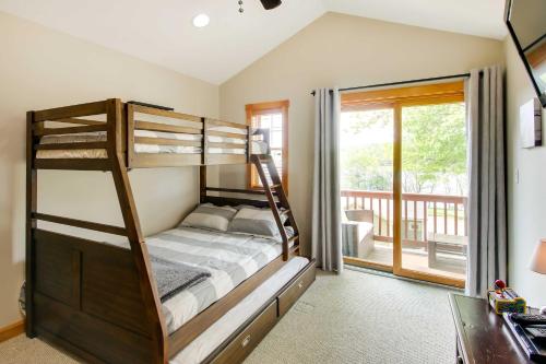 a bedroom with bunk beds and a balcony at Laconia Home with Beach - half Mi to Weirs Beach in Laconia