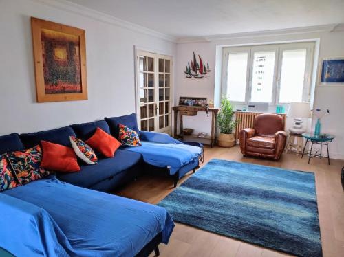 a living room with blue couches and a blue rug at Villa METICA - Aussillon/Mazamet in Aussillon