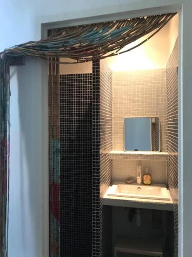 a bathroom with a sink and a mirror at Maison 180 m2 avec bassin-piscine en bois à Vauban in Marseille