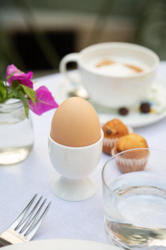 a table with a egg and a cup of coffee and donuts at Can Moio Turismo de Interior in Montuiri