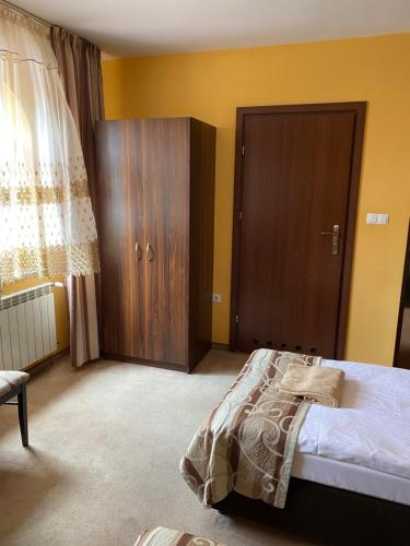 a bedroom with a bed and a wooden cabinet at Zajazd Miechus in Miechów