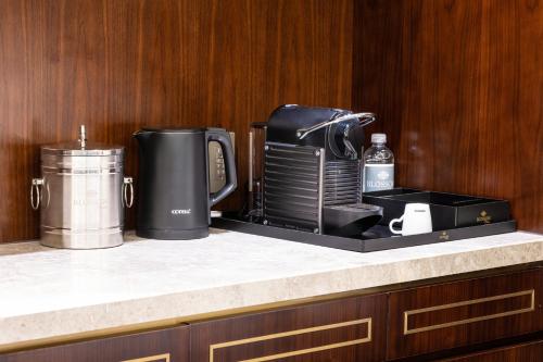a counter with a coffeemaker and a coffee maker at Blossom Hotel Houston, Curio Collection by Hilton in Houston
