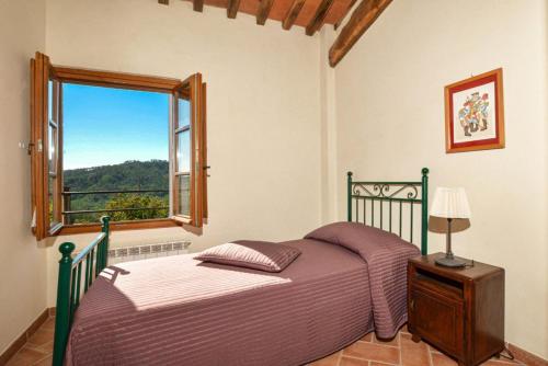 a bedroom with a bed and a window at Villa Casale Di Rosa in Lucca