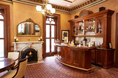 a bar in a room with a fireplace at Mansion Hill Inn in Madison