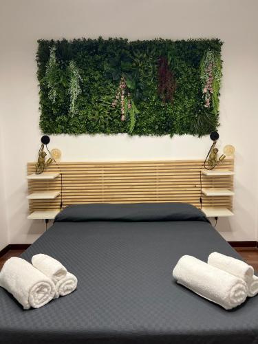a bedroom with a bed with two towels on it at Tropical house in Lecce