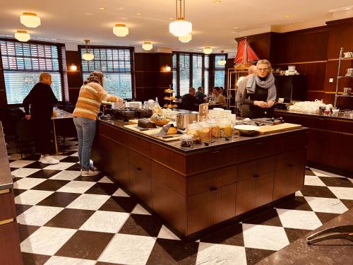 a group of people preparing food in a kitchen at Gatsby Hotel - Adults Only - Small Luxury Hotel - by F-Hotels in Blankenberge
