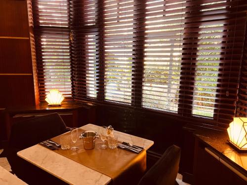 a dining room with a table and a window at Gatsby Hotel - Adults Only - Small Luxury Hotel - by F-Hotels in Blankenberge