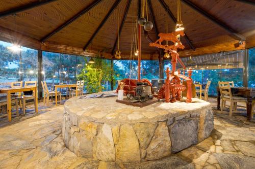 a large stone table in a dining room with a large window at Aral Tatil Ciftligi in Bozcaada