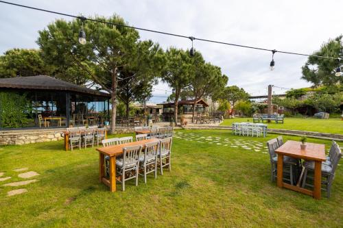 a group of tables and chairs in a park at Aral Tatil Ciftligi in Bozcaada