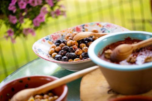 a table with two bowls of food and a bowl of berries at Aral Tatil Ciftligi in Bozcaada