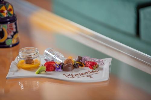 a plate of candy and fruit on a table at Presidente InterContinental Puebla by IHG in Puebla