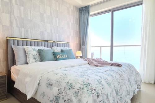 1 dormitorio con cama y ventana grande en A Perfect Escape - Sea facing en Ras al-Jaima