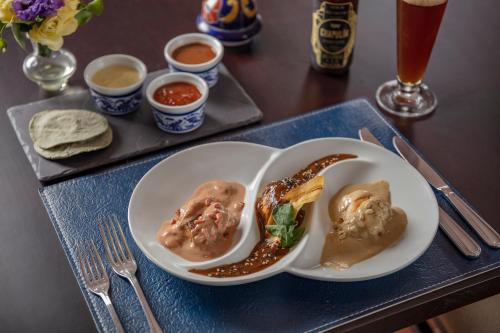 a tray with two plates of food on a table at Presidente InterContinental Puebla by IHG in Puebla