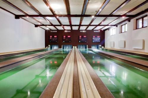 a bowling alley with lanes in a building at Parkhotel Matrei in Matrei am Brenner