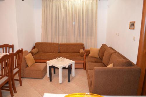 a living room with a couch and a table at Maria Apartment in Gjirokastër