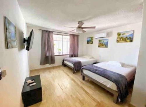 a bedroom with two beds and a table at Rooftop penthouse 3 bedrooms, Sleeps 8! in Cancún