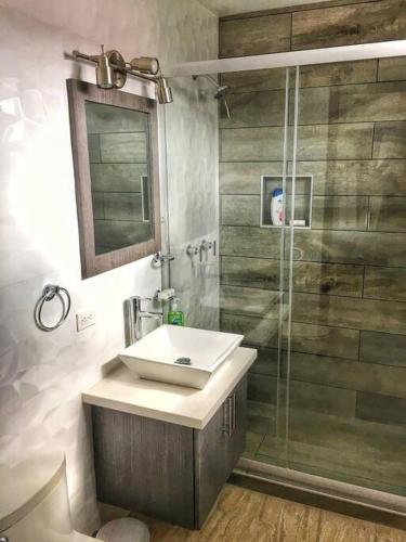 a bathroom with a sink and a shower at Rooftop penthouse 3 bedrooms, Sleeps 8! in Cancún