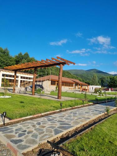 a park with a pavilion in front of a building at Doka Valea Sebesului A-Frame in Sebeşu