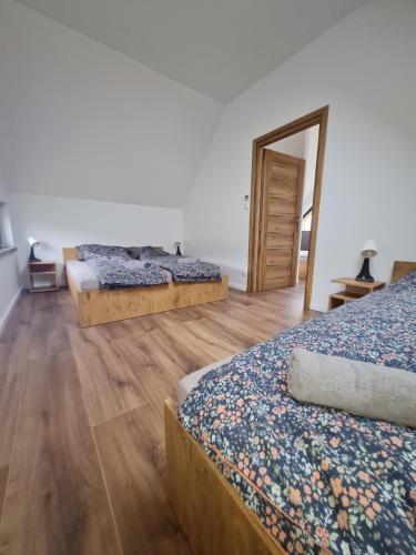 a room with three beds and a mirror at Bocheniówka in Nowy Targ