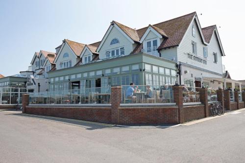 a large building with people sitting inside of it at Botany Bay Hotel in Broadstairs
