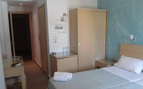a hotel room with a bed and a cabinet at Blue Harmony Hotel in Kinion