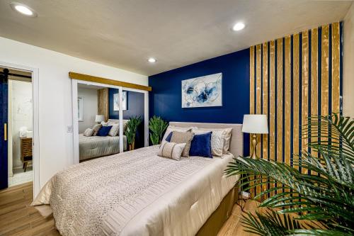 a bedroom with a large bed with blue walls at Palm Springs BLUE DESERT Condo! in Palm Springs