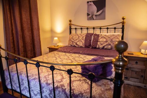 a bedroom with a bed and two night stands and two lamps at Groveside Holiday Lets in Saltburn-by-the-Sea