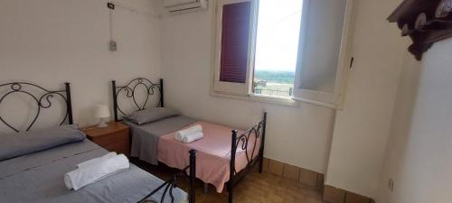 two twin beds in a room with a window at Consoli Crispino in Francolise