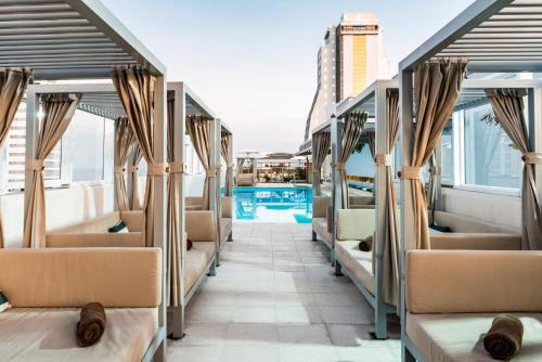 a row of seats on a train with a pool at Holiday Inn Express - Cartagena Bocagrande, an IHG Hotel in Cartagena de Indias