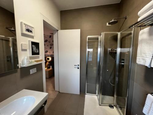 a bathroom with a shower and a sink at JO Hotel in Marano Lagunare