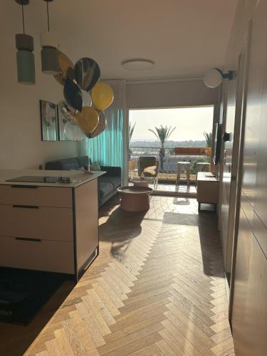 a room with a kitchen with a view of the ocean at lasuita- exclusive suites cesarea- sea view suite in Caesarea