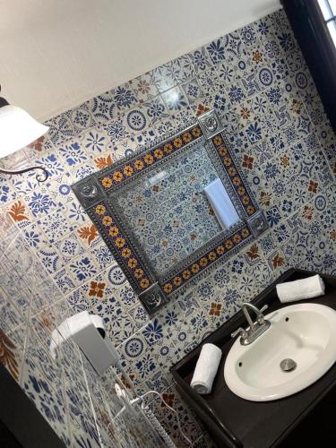 a bathroom with a sink and a mirror at Casa Yollotzin in Ajijic