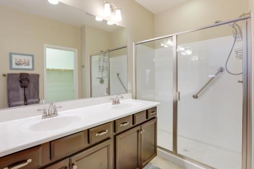 a bathroom with two sinks and a shower at Resort Amenities and Patio at 55 and Goodyear Escape! in Goodyear