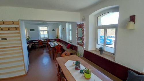 a living room with a table and a dining room at Haus Waldschänke in Erlbach