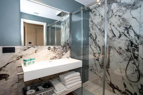 a bathroom with a sink and a shower at Hotel Barcarola 2 in Marina di Campo