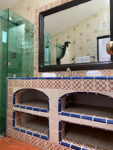 a bathroom with a sink and a mirror at Casa Yollotzin in Ajijic