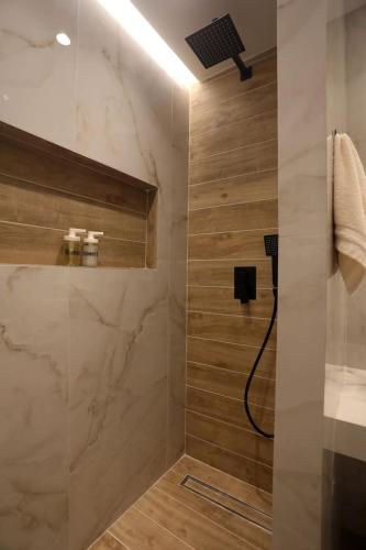 a bathroom with a shower with a sink and a shower at Calma Resort in Skala Fourkas