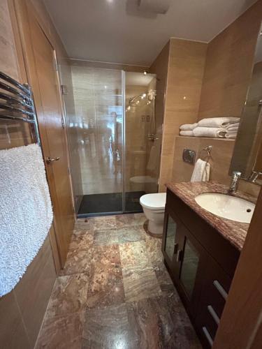 a bathroom with a shower and a toilet and a sink at Ocean Village Luxury 2 Bed 2 Bath Apartment - amazing views - pools and jacuzzis in Gibraltar