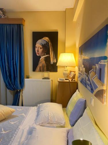 a bedroom with a bed and a painting of a woman at Πηνελόπη Apartment 3-bed flat in Tripolis